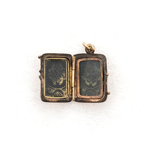 This petite rectangular locket features a basket weave pattern with a seed pearl on one side and a strip of black onyx on the other. It opens to hold two photos, includes both original frames and glass and pairs perfectly with one of our antique gold fill chains.  Open Locket View