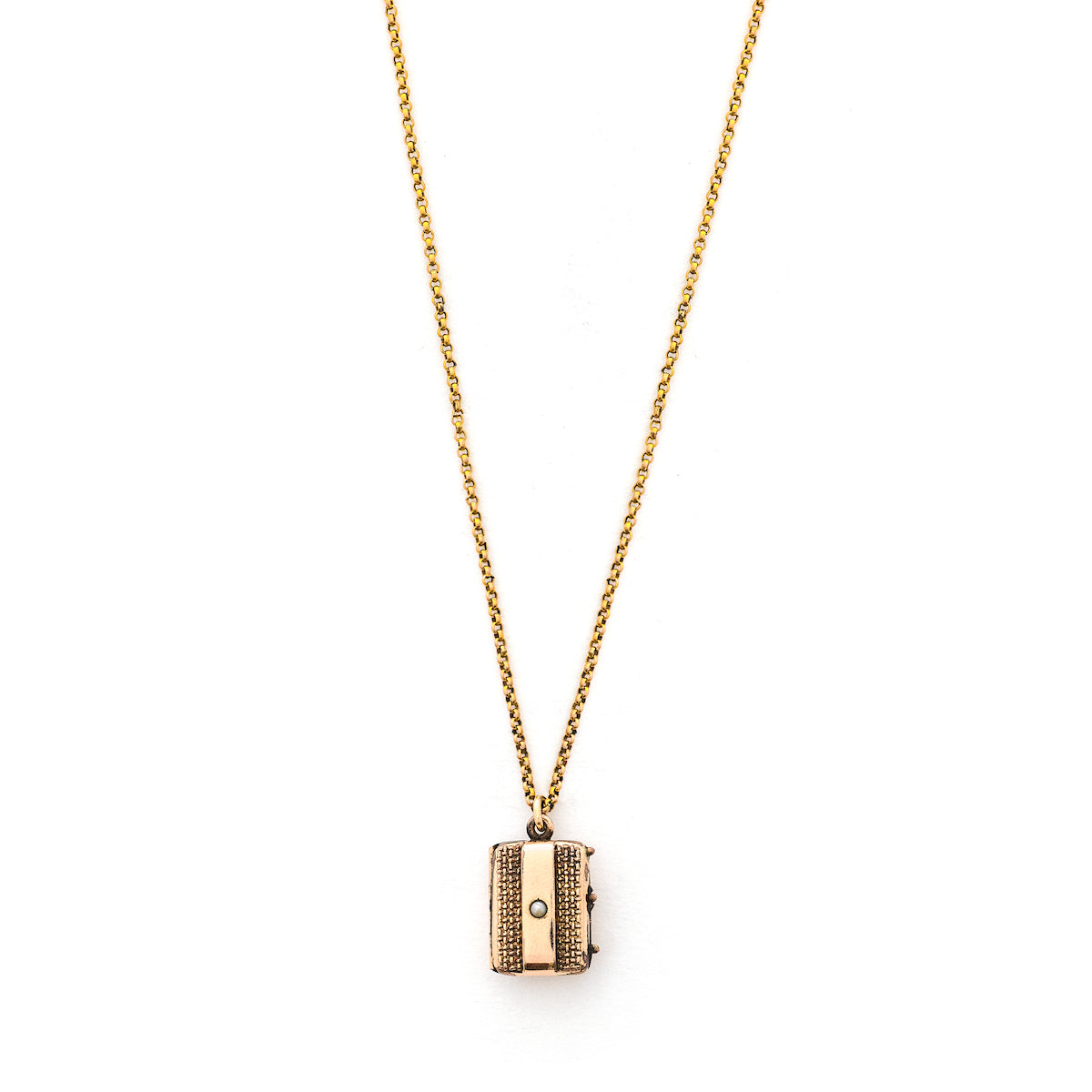 This petite rectangular locket features a basket weave pattern with a seed pearl on one side and a strip of black onyx on the other. It opens to hold two photos, includes both original frames and glass and pairs perfectly with one of our antique gold fill chains. Front Locket view, shown on chain