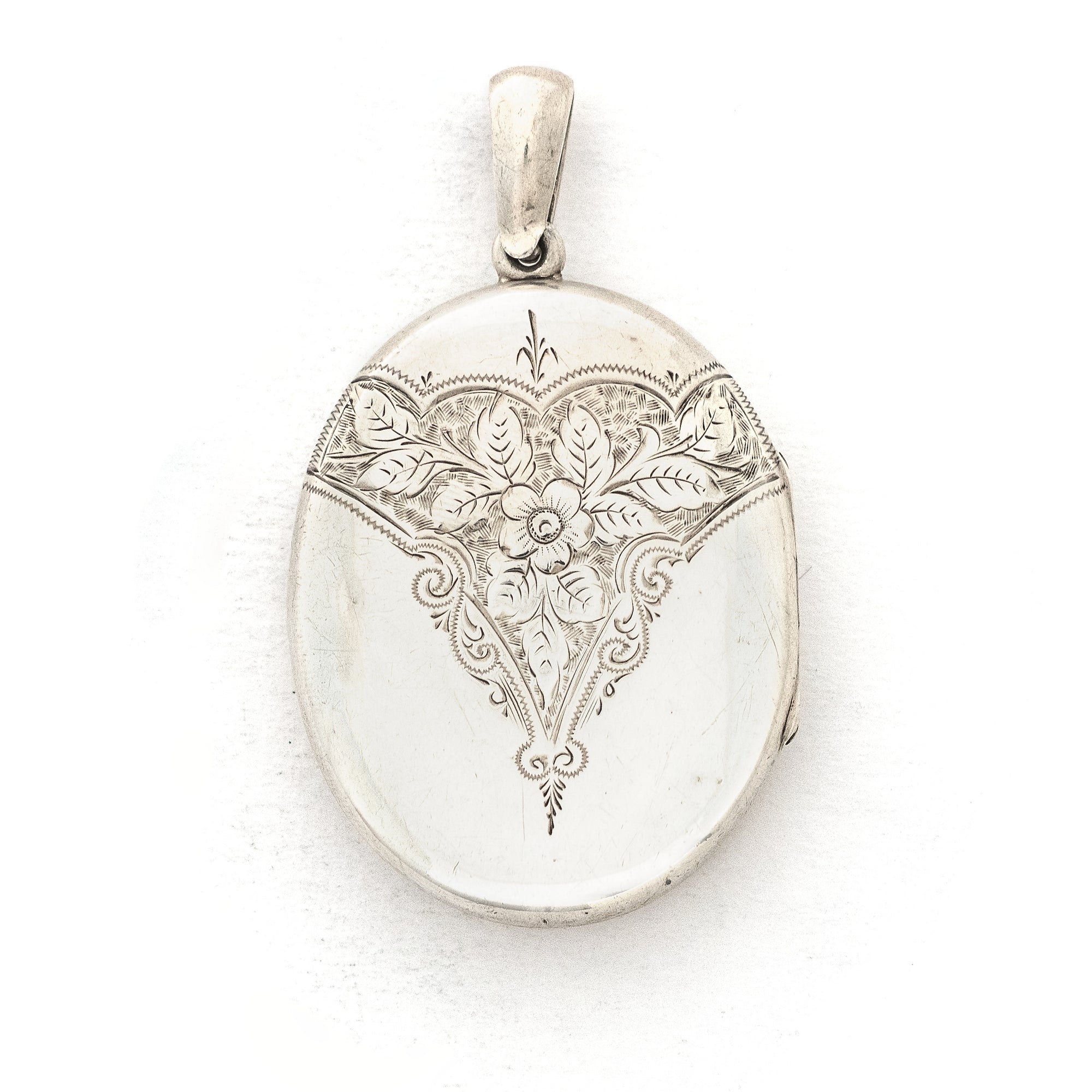 This large sterling silver oval locket features the classic Victorian symbol, a forget-me-not flower surrounded by greenery in a dramatic deep V shape and opens to hold two photos. We have paired this locket with an exquisite engraved Victorian sterling silver book chain from the same era. Front Locket view