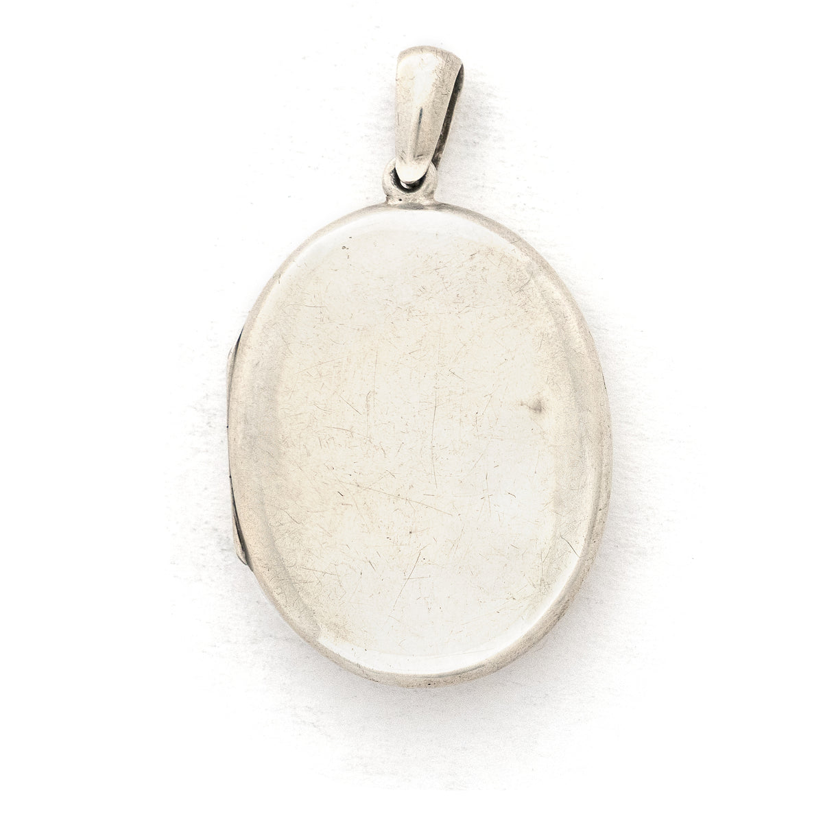 This large sterling silver oval locket features the classic Victorian symbol, a forget-me-not flower surrounded by greenery in a dramatic deep V shape and opens to hold two photos. We have paired this locket with an exquisite engraved Victorian sterling silver book chain from the same era. Back locket view