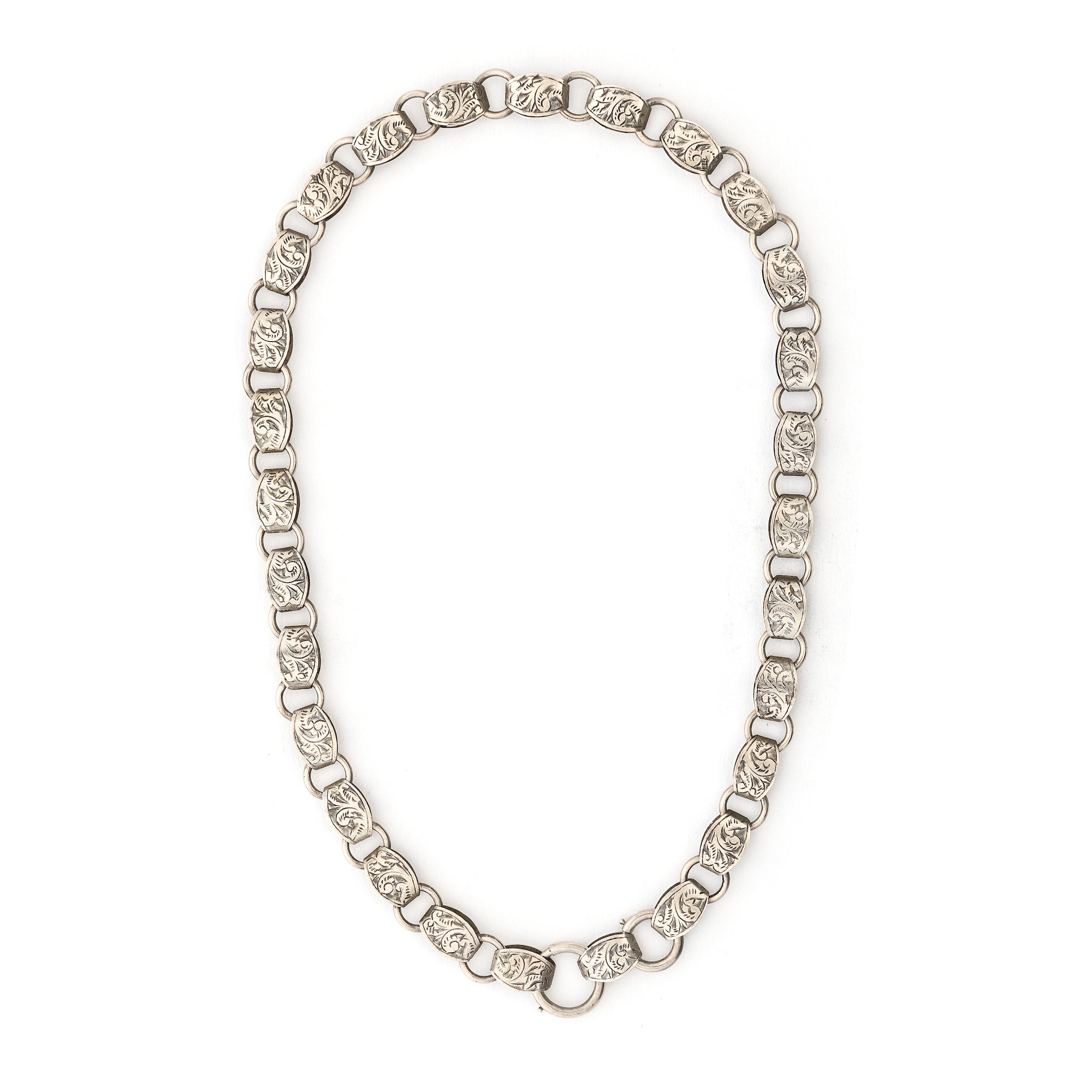 This statement making sterling silver antique book chain features finely engraved oval links, a treasure from the Victorian era. Wear this piece alone, with charms or a locket, or layered with other chains for a bold statement. Close up view