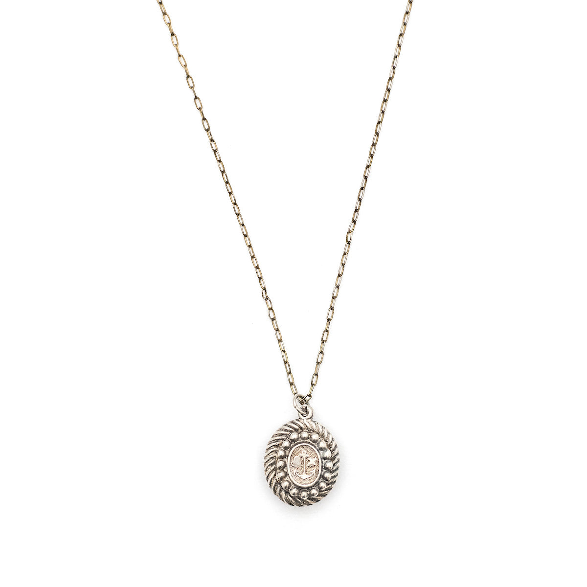 This oval sterling silver locket features an anchor, heart and cross at its center with surrounding filigree and rope patterns. The back of the locket is the same as the front. It opens to hold one photo and pairs perfectly with one of our antique sterling silver chains. Front locket view, shown on chain