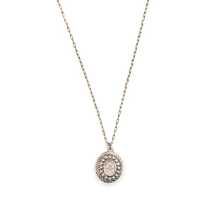 This oval sterling silver locket features an anchor, heart and cross at its center with surrounding filigree and rope patterns. The back of the locket is the same as the front. It opens to hold one photo and pairs perfectly with one of our antique sterling silver chains. Front locket view, shown on chain