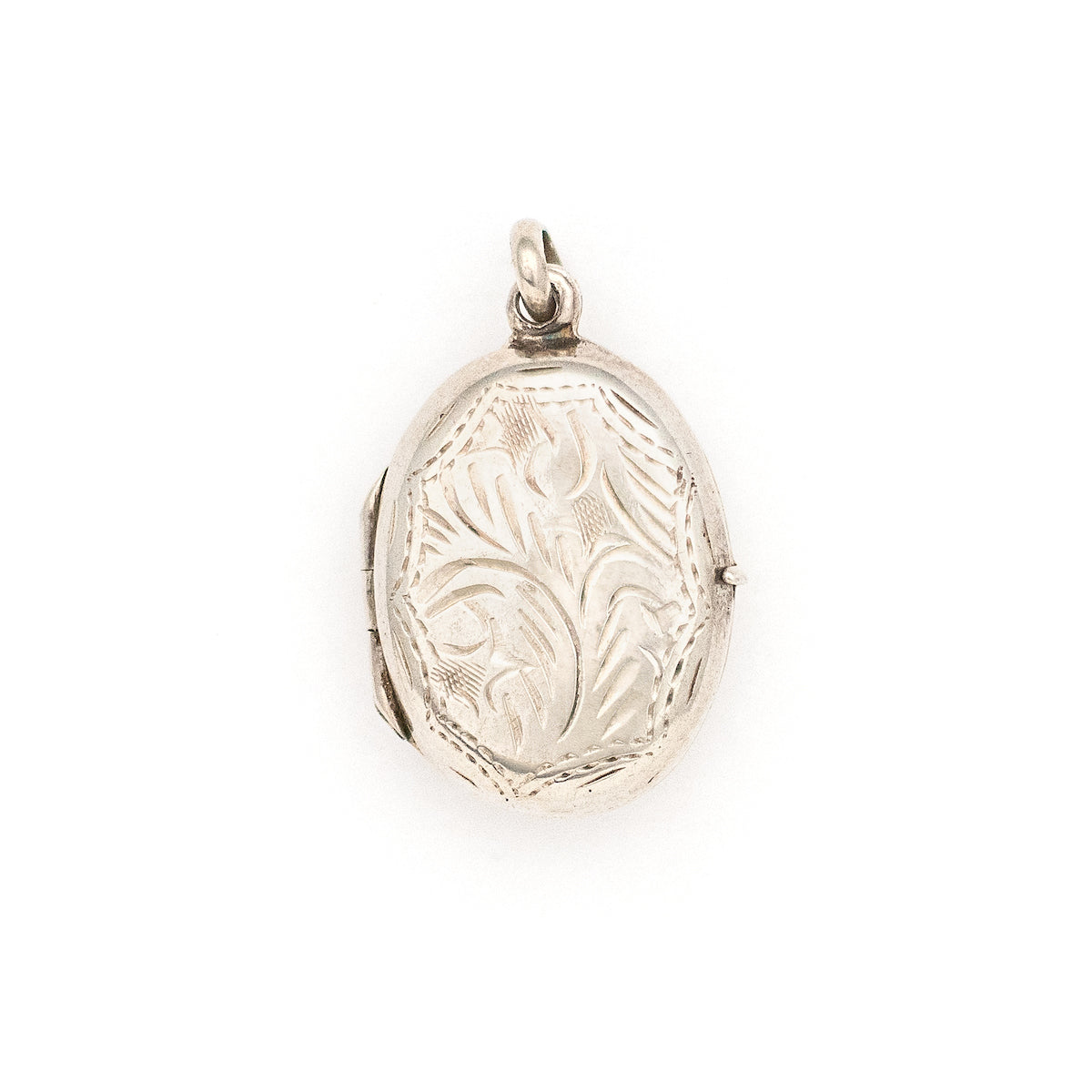 This oval sterling silver vintage locket features banded dark green malachite at its center with a beautifully etched leafed design on the back . It opens to hold two photos and pairs perfectly with one of our antique sterling silver chains. Back locket view