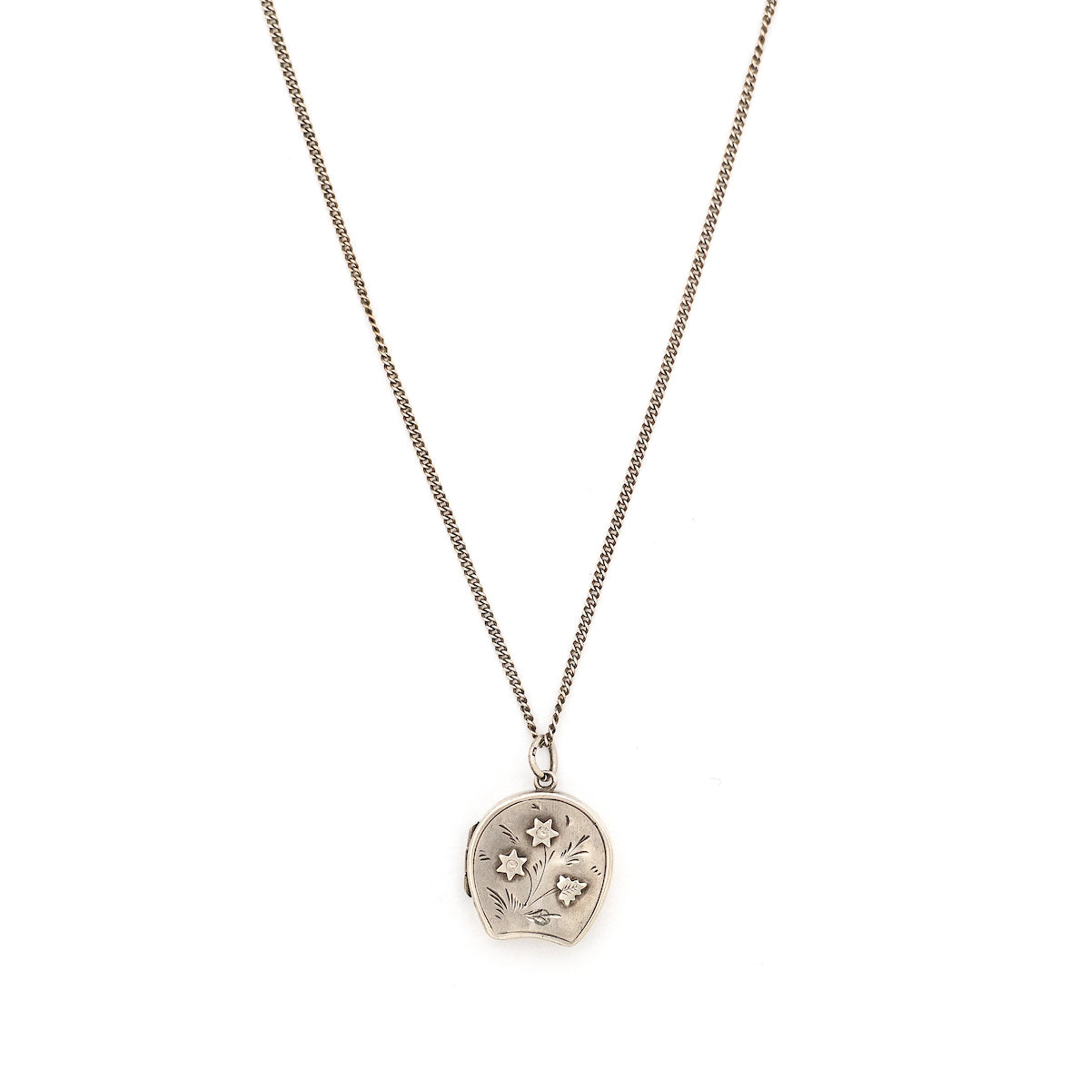 This horseshoe-shaped oval English sterling silver locket features two star flowers and one leaf in raised relief with delicately etched stems and leaves in the background. It has been hallmarked for Birmingham, 1901, opens to hold two photos and pairs perfectly with one of our vintage sterling silver chains. Front locket view, shown on chain