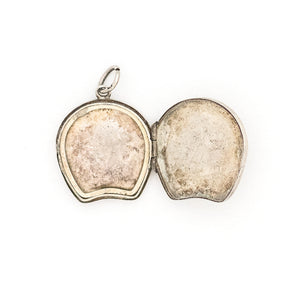 This horseshoe-shaped oval English sterling silver locket features two star flowers and one leaf in raised relief with delicately etched stems and leaves in the background. It has been hallmarked for Birmingham, 1901, opens to hold two photos and pairs perfectly with one of our vintage sterling silver chains. Open locket view