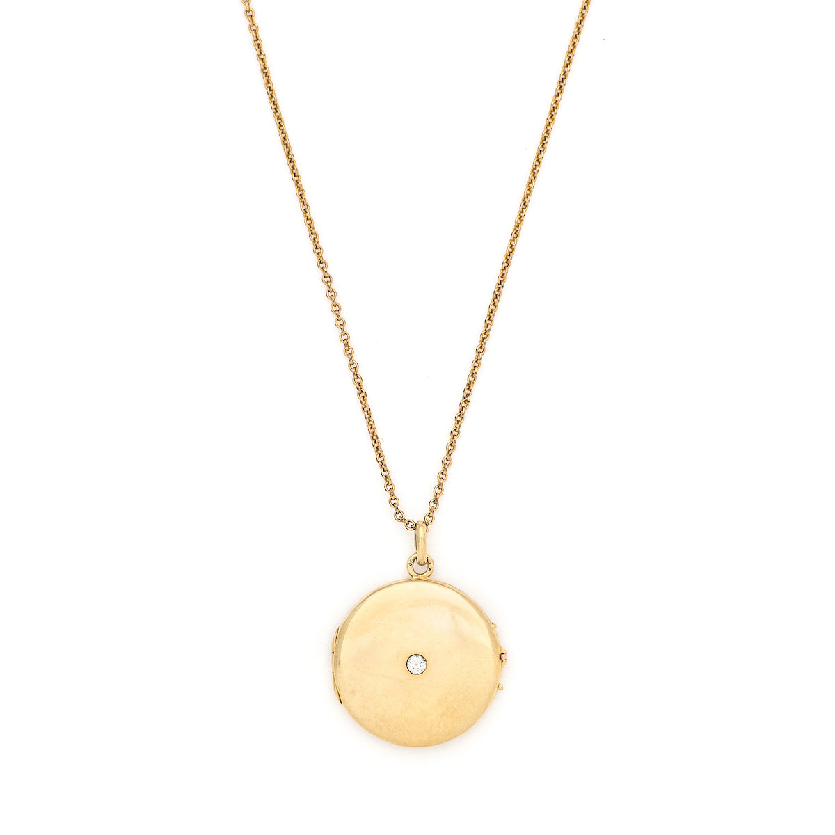This beautifully simple 14K gold locket features a 10 point genuine diamond at its center. It opens to hold one photo, includes one original frame and pairs perfectly with one of our antique 14K gold chains.  Front locket view, shown on chain
