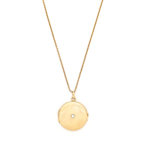This beautifully simple 14K gold locket features a 10 point genuine diamond at its center. It opens to hold one photo, includes one original frame and pairs perfectly with one of our antique 14K gold chains.  Front locket view, shown on chain
