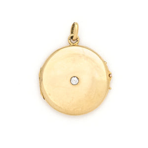 This beautifully simple 14K gold locket features a 10 point genuine diamond at its center. It opens to hold one photo, includes one original frame and pairs perfectly with one of our antique 14K gold chains.  Front locket view