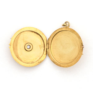 This beautifully simple 14K gold locket features a 10 point genuine diamond at its center. It opens to hold one photo, includes one original frame and pairs perfectly with one of our antique 14K gold chains.  Open locket view