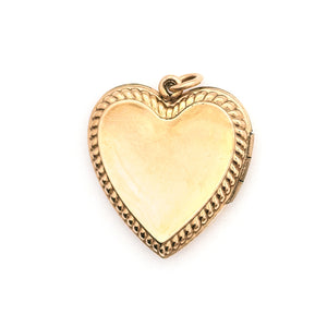 This sweet heart-shaped locket features white and green paste stones set in an equal-sided Greek cross at its center, surrounded by a charming rope border. In antiquity, the equal arms of a Greek cross symbolized the four main elements of nature: air, fire, water, earth. The locket opens to hold two photos, includes both original frames and pairs perfectly with one of our antique gold fill chains.  Back locket view