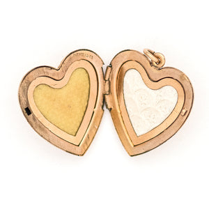 This sweet heart-shaped locket features white and green paste stones set in an equal-sided Greek cross at its center, surrounded by a charming rope border. In antiquity, the equal arms of a Greek cross symbolized the four main elements of nature: air, fire, water, earth. The locket opens to hold two photos, includes both original frames and pairs perfectly with one of our antique gold fill chains.  Open locket view