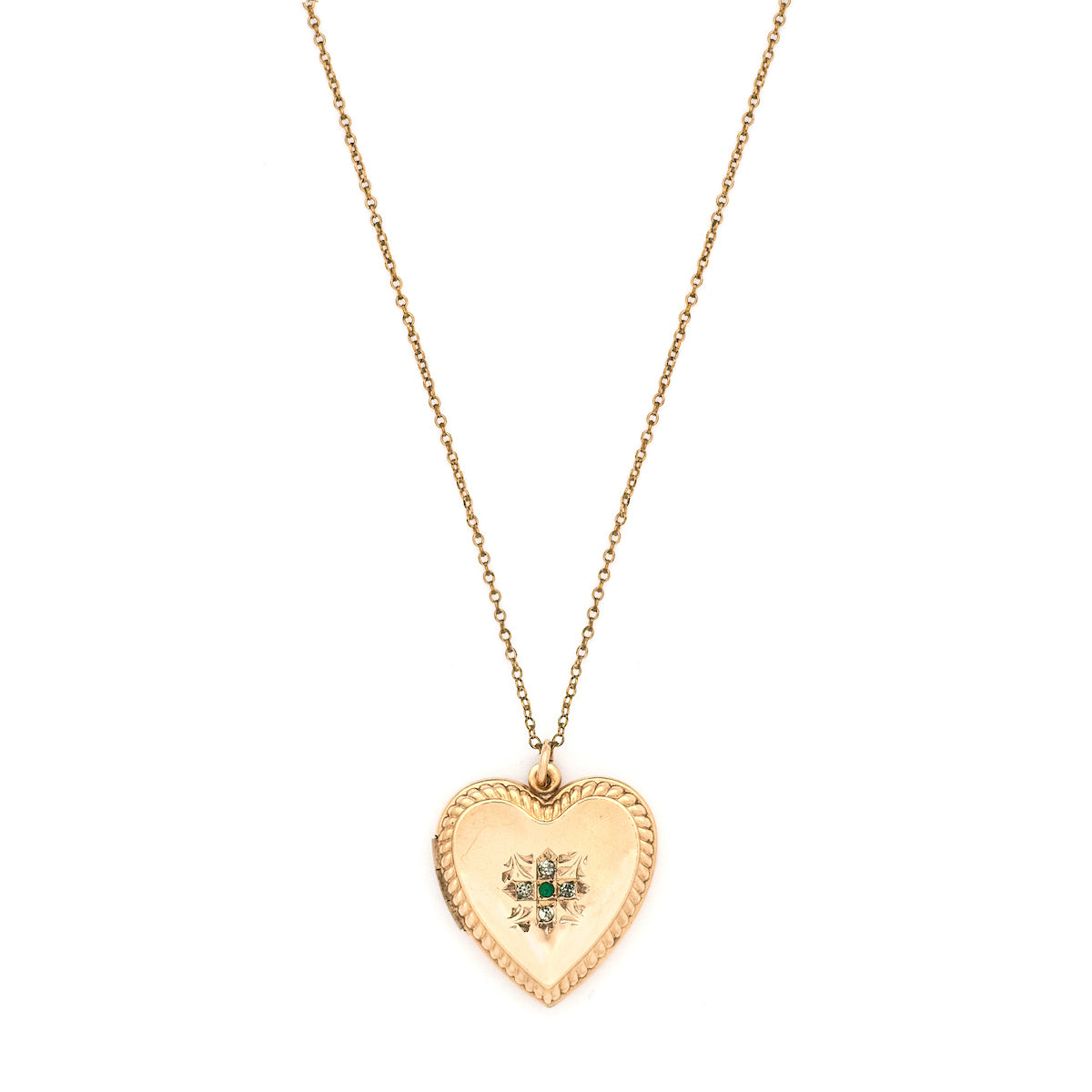 This sweet heart-shaped locket features white and green paste stones set in an equal-sided Greek cross at its center, surrounded by a charming rope border. In antiquity, the equal arms of a Greek cross symbolized the four main elements of nature: air, fire, water, earth. The locket opens to hold two photos, includes both original frames and pairs perfectly with one of our antique gold fill chains.  Front locket view