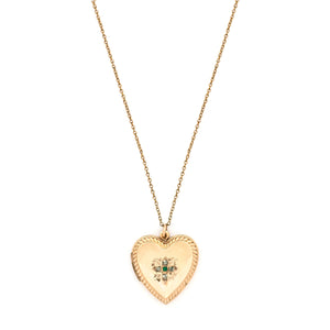 This sweet heart-shaped locket features white and green paste stones set in an equal-sided Greek cross at its center, surrounded by a charming rope border. In antiquity, the equal arms of a Greek cross symbolized the four main elements of nature: air, fire, water, earth. The locket opens to hold two photos, includes both original frames and pairs perfectly with one of our antique gold fill chains.  Front locket view, shown on chain