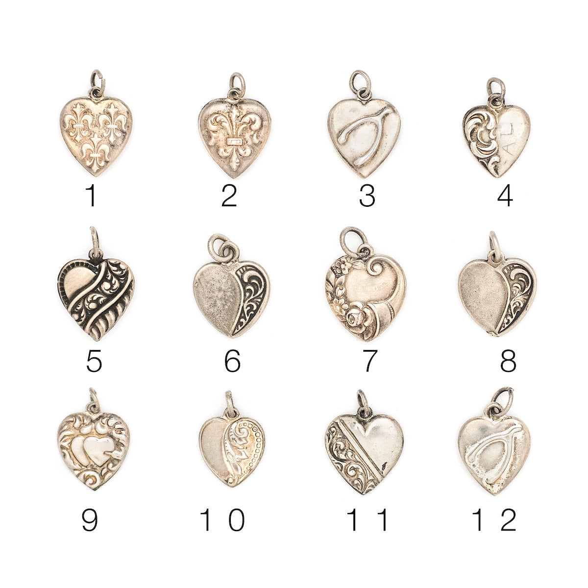 This collection of sterling silver heart charm came to us from a private collection and features something for everyone. Each charm is unique and sweet with enchanting details. Paired with one of our new silver chains, these adorable heart charms can be worn both as a pendant or in a cluster of charms. Front charm view