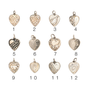 This collection of sterling silver heart charm came to us from a private collection and features something for everyone. Each charm is unique and sweet with enchanting details. Paired with one of our new silver chains, these adorable heart charms can be worn both as a pendant or in a cluster of charms. Front charm view, showing numbers