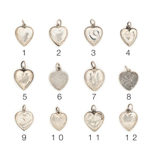 This collection of sterling silver heart charm came to us from a private collection and features something for everyone. Each charm is unique and sweet with enchanting details. Paired with one of our new silver chains, these adorable heart charms can be worn both as a pendant or in a cluster of charms. Back charm view, showing numbers