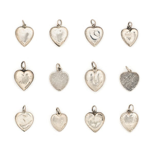 This collection of sterling silver heart charm came to us from a private collection and features something for everyone. Each charm is unique and sweet with enchanting details. Paired with one of our new silver chains, these adorable heart charms can be worn both as a pendant or in a cluster of charms. Back charm view