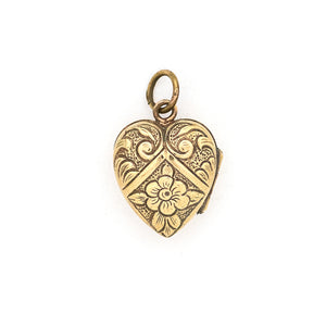This sweet vintage heart-shaped locket features seven white glass stones in the shape of a snowflake with an intricate forget-me-not design on the back. It opens to hold one photo, includes one original frame and pairs perfectly with one of our antique gold fill chains.  Back locket view