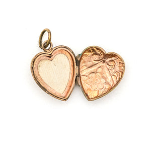 This sweet vintage heart-shaped locket features seven white glass stones in the shape of a snowflake with an intricate forget-me-not design on the back. It opens to hold one photo, includes one original frame and pairs perfectly with one of our antique gold fill chains. Open locket view