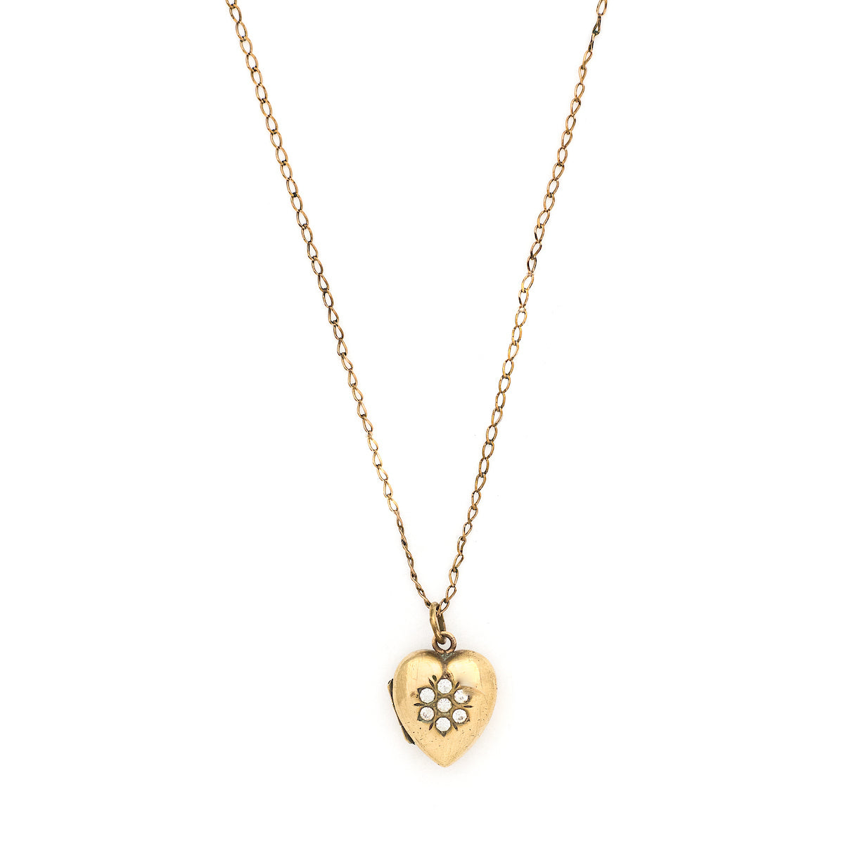 This sweet vintage heart-shaped locket features seven white glass stones in the shape of a snowflake with an intricate forget-me-not design on the back. It opens to hold one photo, includes one original frame and pairs perfectly with one of our antique gold fill chains.  Front locket view