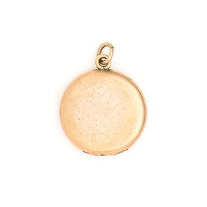 This lively round locket features a repeating curlicue and swirl pattern which covers the entire locket face. It opens to hold two photos, includes both original frames and pairs perfectly with one of our antique gold fill chains. Back locket view