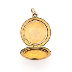 This lively round locket features a repeating curlicue and swirl pattern which covers the entire locket face. It opens to hold two photos, includes both original frames and pairs perfectly with one of our antique gold fill chains. Open locket view