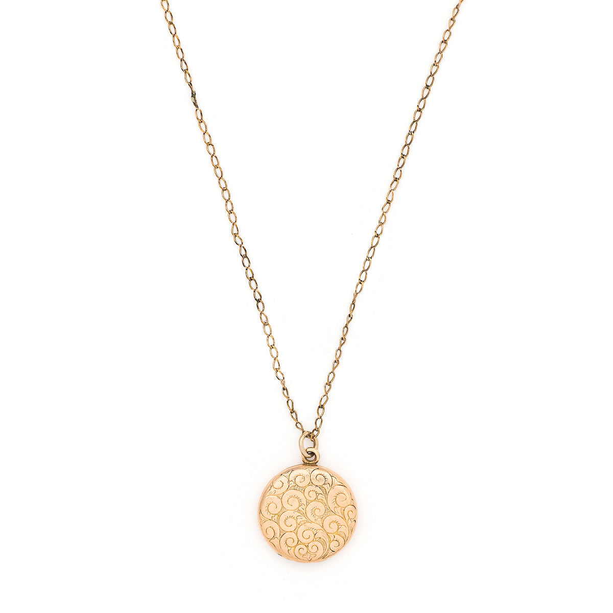 This lively round locket features a repeating curlicue and swirl pattern which covers the entire locket face. It opens to hold two photos, includes both original frames and pairs perfectly with one of our antique gold fill chains. Front locket view, shown on chain