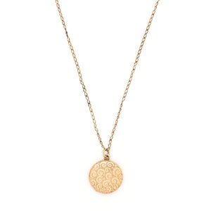 This lively round locket features a repeating curlicue and swirl pattern which covers the entire locket face. It opens to hold two photos, includes both original frames and pairs perfectly with one of our antique gold fill chains. Front locket view, shown on chain