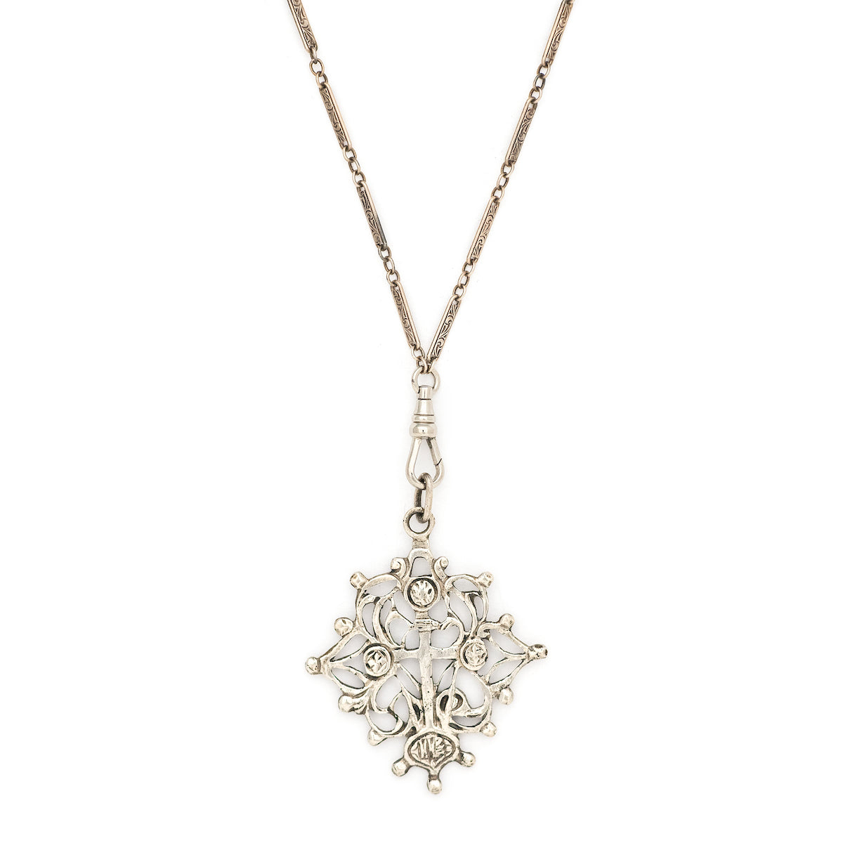 This grand sterling silver pendant features a cross surrounded by ornate vines.  Paired with our antique sterling silver bar link watch chain, this pendant can be worn both as a pendant or in a cluster of charms.  Front charm view