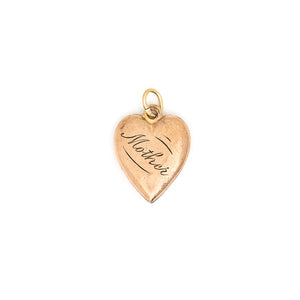 This petite heart shaped charm features turquoise at its center with a raised relief off center design around the edges. "Mother" is lovingly hand-engraved on the back in perfect calligraphy. This meaningful gift for mom pairs perfectly with one of our antique chains. Back charm view, shows Mother inscription