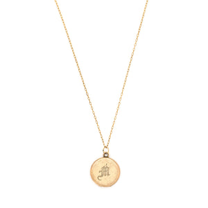This petite round locket features a simple "M" in Old English script. It opens to hold two photos, includes both original frames and pairs perfectly with one of our antique gold fill chains. Front locket view, shown on chain