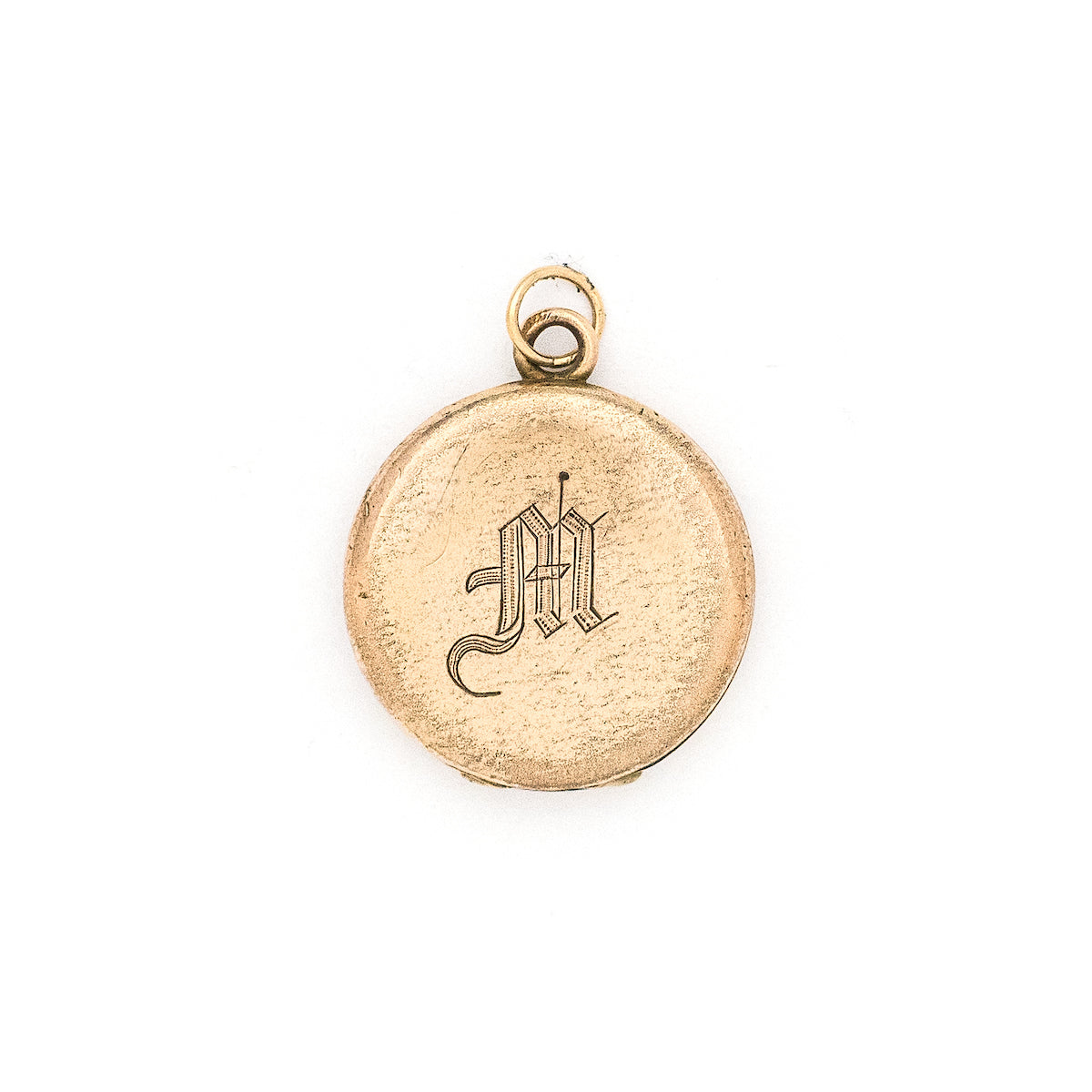 This petite round locket features a simple "M" in Old English script. It opens to hold two photos, includes both original frames and pairs perfectly with one of our antique gold fill chains. Front locket view