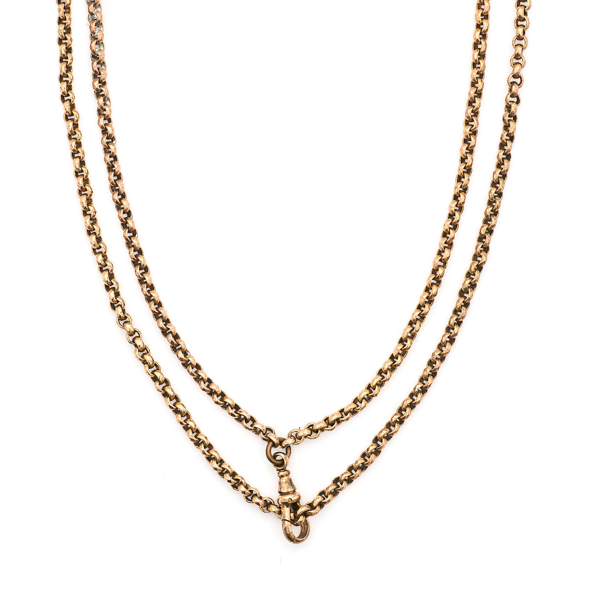 This Pinchbeck antique watch chain features ever so slightly textured circular links, creating a light catching cable style chain, complete with a watch chain clasp. Close up view, with clasp