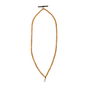 This unusual watch chain is made of finely woven rattan links creating a three dimensional cable style chain, complete with a T bar and hook clasp. Measuring at a very wearable 24" long, you can wear this chain layered with other pieces or alone paired with one of our antique gold fill lockets or charms. Full chain view