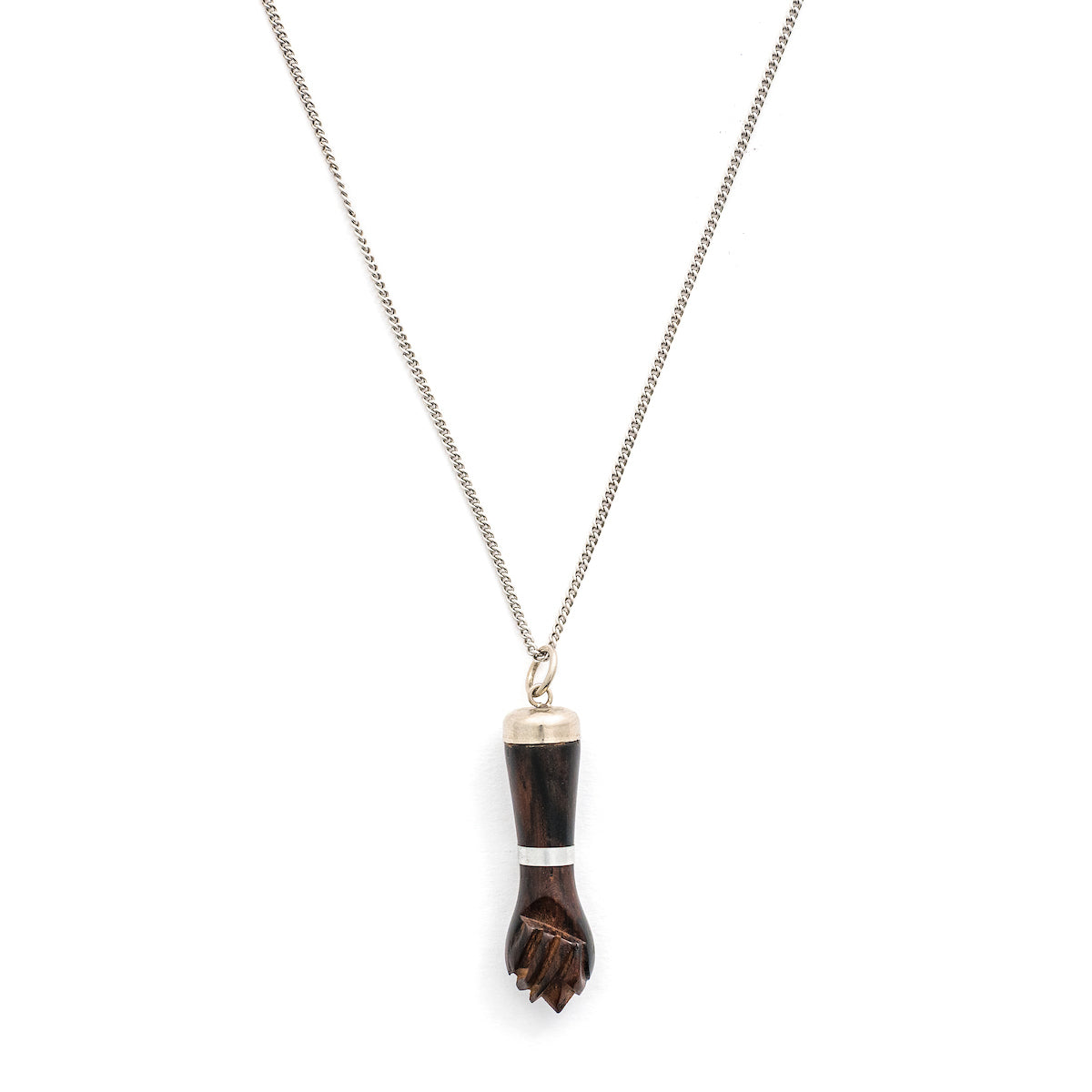 This unique figa hand charm is made of walnut wood and features sterling silver accents including the bail and a bracelet on the wrist. The figa symbol dates back to ancient times and in modern day is seen as a sign of female strength and empowerment. Paired with one of our antique sterling silver chains, this charm can be worn both as a pendant or in a cluster of charms.  Front charm view