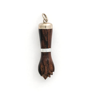 This unique figa hand charm is made of walnut wood and features sterling silver accents including the bail and a bracelet on the wrist. The figa symbol dates back to ancient times and in modern day is seen as a sign of female strength and empowerment. Paired with one of our antique sterling silver chains, this charm can be worn both as a pendant or in a cluster of charms.  Charm view