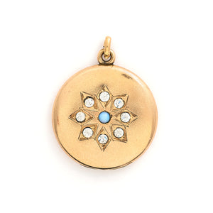 This round locket features a gorgeous opal at the center of a snowflake design, complete with white glass stones at each of the points. It opens to hold one photo, includes one original frame and pairs perfectly with one of our antique gold fill chains. Front locket view