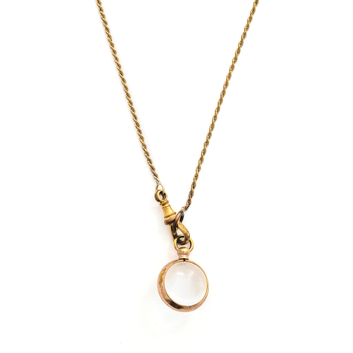 This Pool of Light locket features two halves of a rock crystal joined by a substantial gold fill frame and hinge. It opens to hold two photos that can be seen through the crystal and slightly magnified. Paired with one of our antique gold fill watch chains, this collectors piece will endure for generations to come. Front locket view