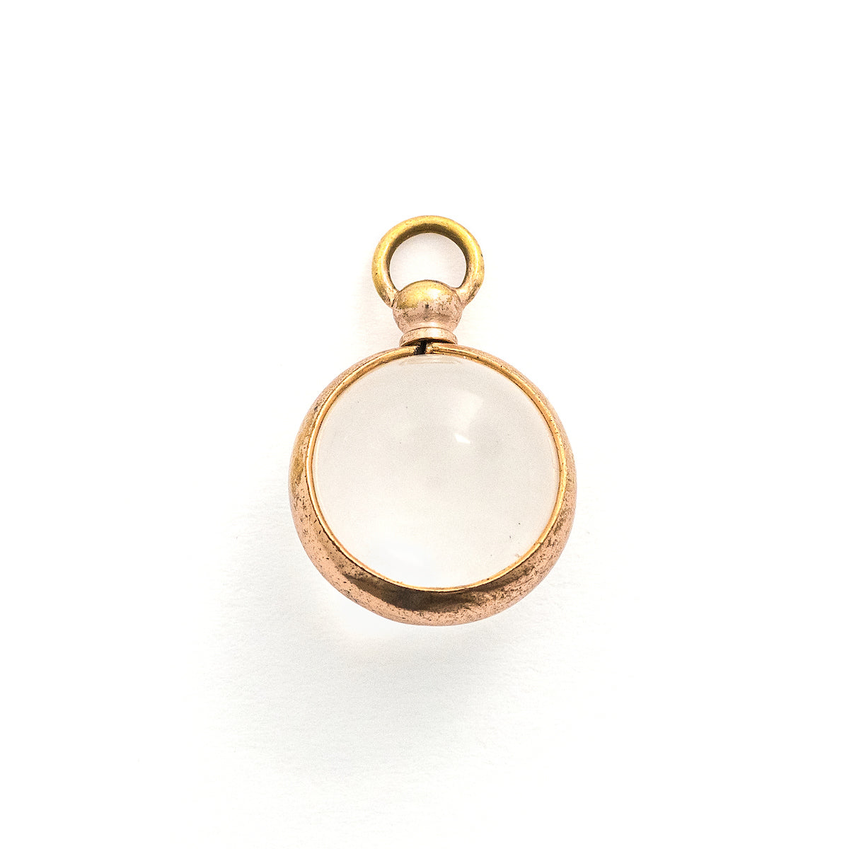 This Pool of Light locket features two halves of a rock crystal joined by a substantial gold fill frame and hinge. It opens to hold two photos that can be seen through the crystal and slightly magnified. Paired with one of our antique gold fill watch chains, this collectors piece will endure for generations to come. Front locket view