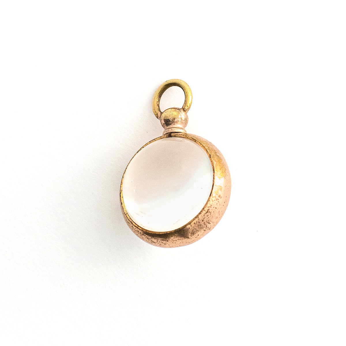 This Pool of Light locket features two halves of a rock crystal joined by a substantial gold fill frame and hinge. It opens to hold two photos that can be seen through the crystal and slightly magnified. Paired with one of our antique gold fill watch chains, this collectors piece will endure for generations to come. Back locket view