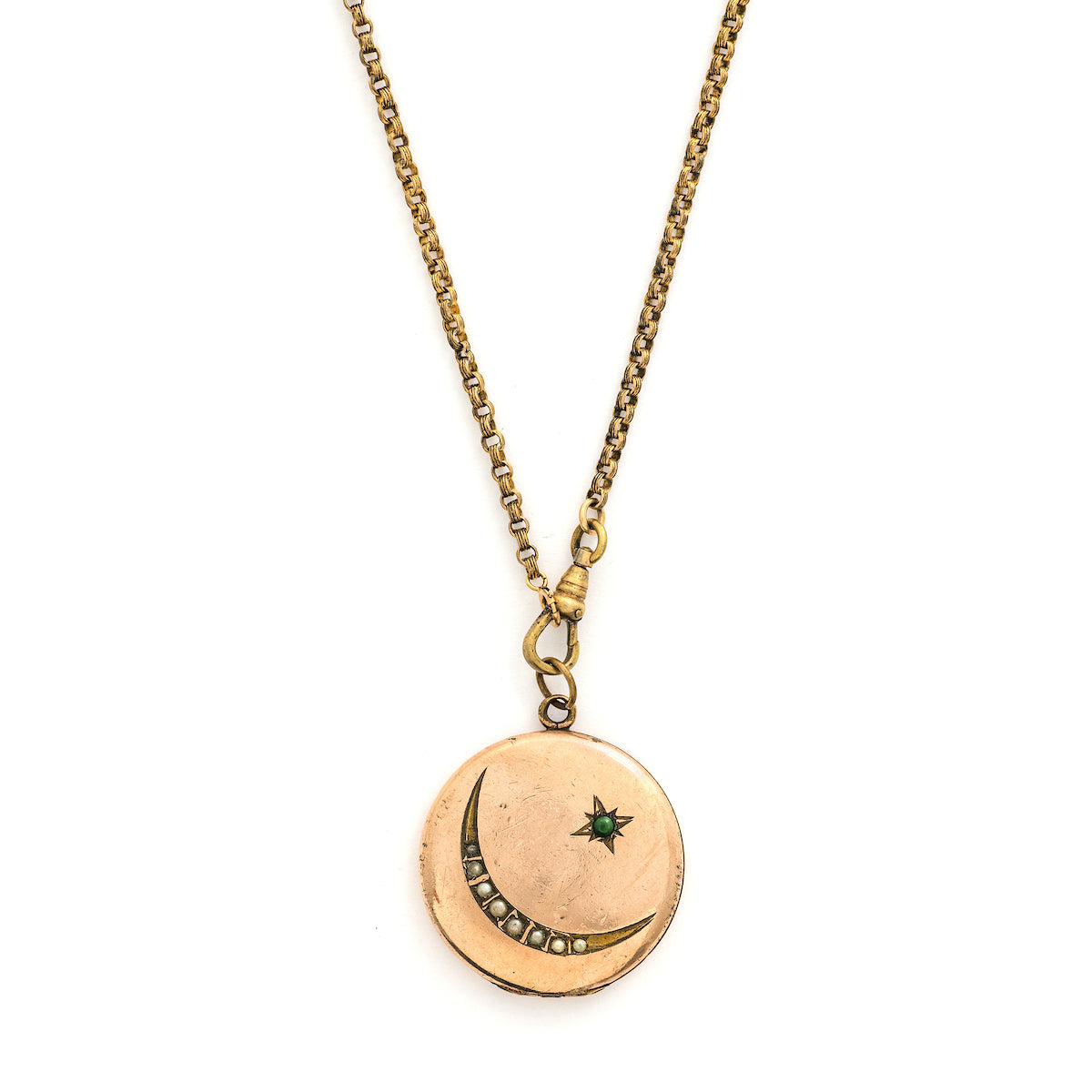 This Victorian round locket features a classic crescent moon and starburst, with a pearl encrusted crescent and jade as the center of the starburst. The letters "JO" are inscribed on the back. It opens to hold two photos and pairs perfectly with one of our antique gold fill chains. Front locket view