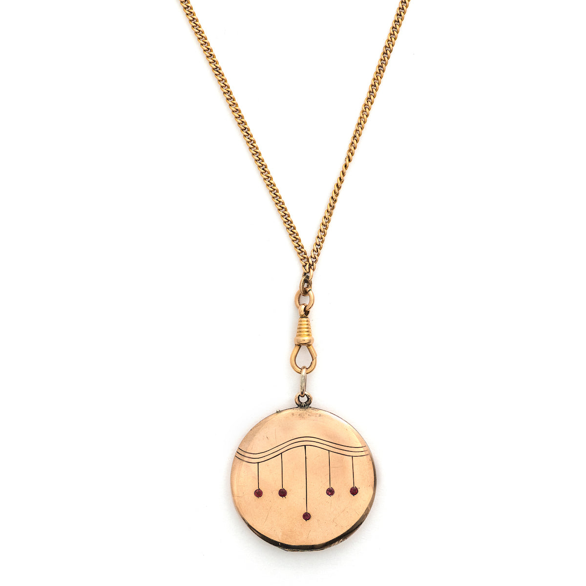 This striking round locket features red stones in a pleasing art deco style pattern. It opens to hold two photos and pairs perfectly with one of our antique gold fill chains.  Front locket view