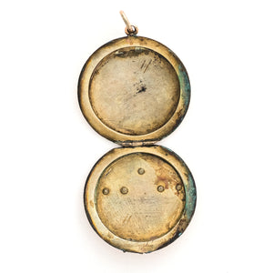 This striking round locket features red stones in a pleasing art deco style pattern. It opens to hold two photos and pairs perfectly with one of our antique gold fill chains.  Open locket view