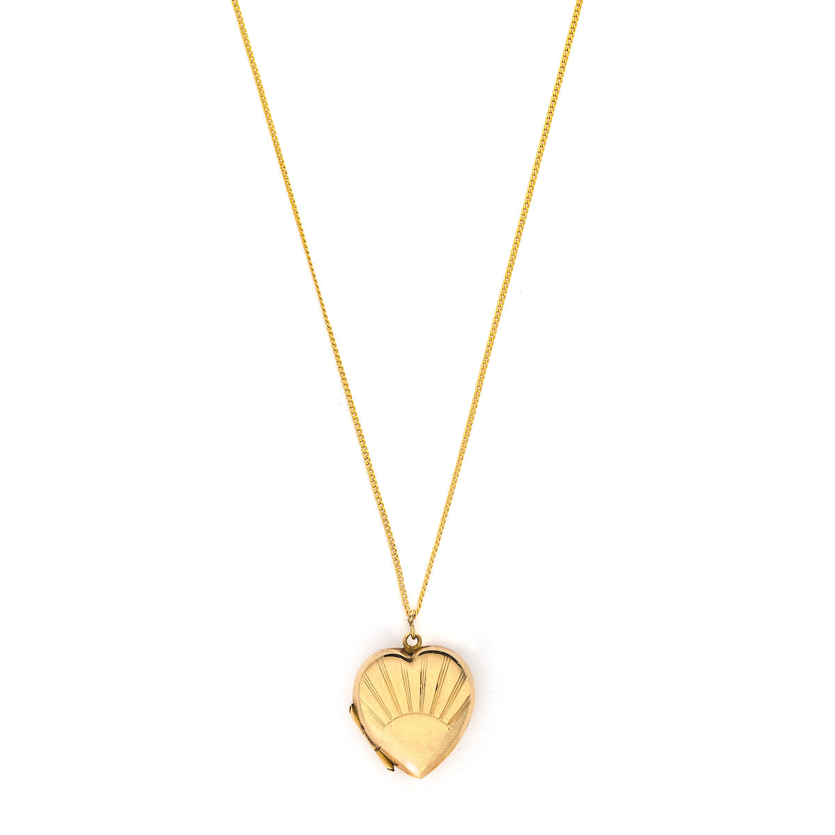 This lustrous 9K gold heart locket features a rising sun design across the entire front. It opened to hold two photos, has both original frames and paired with one of our vintage gold chains, this locket is the perfect symbol of love and new beginnings. Front locket view