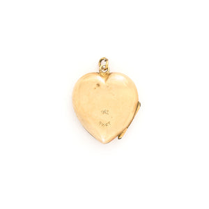 This lustrous 9K gold heart locket features a rising sun design across the entire front. It opened to hold two photos, has both original frames and paired with one of our vintage gold chains, this locket is the perfect symbol of love and new beginnings. Back locket view