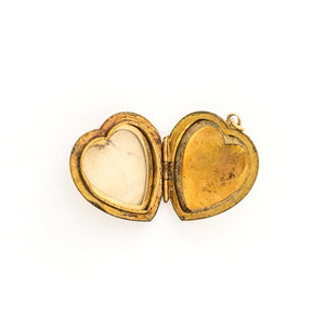 This lustrous 9K gold heart locket features a rising sun design across the entire front. It opened to hold two photos, has both original frames and paired with one of our vintage gold chains, this locket is the perfect symbol of love and new beginnings. Open locket view