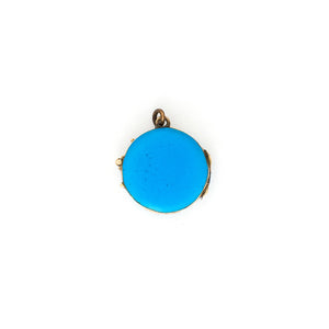 This petite round locket features striking cerulean blue enamel with a 14K gold Star of David at its center and a matching 14K gold border. It opens to hold two photos, includes one original glass and pairs perfectly with one of our antique gold chains. Back locket view