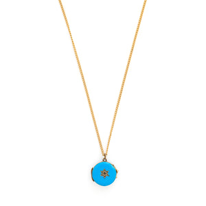 This petite round locket features striking cerulean blue enamel with a 14K gold Star of David at its center and a matching 14K gold border. It opens to hold two photos, includes one original glass and pairs perfectly with one of our antique gold chains. Front locket view, shown on chain