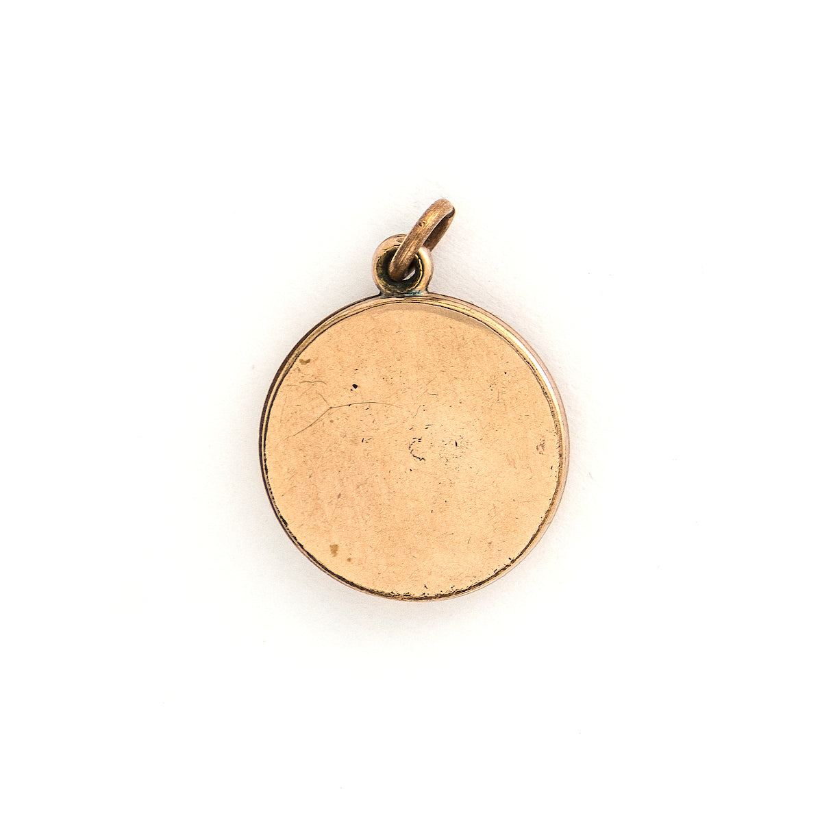 This simple round slide locket features 3 white glass stones and a minimalist thirds design. It slides opens to hold two photos and pairs perfectly with one of our antique gold fill chains.  Back locket view